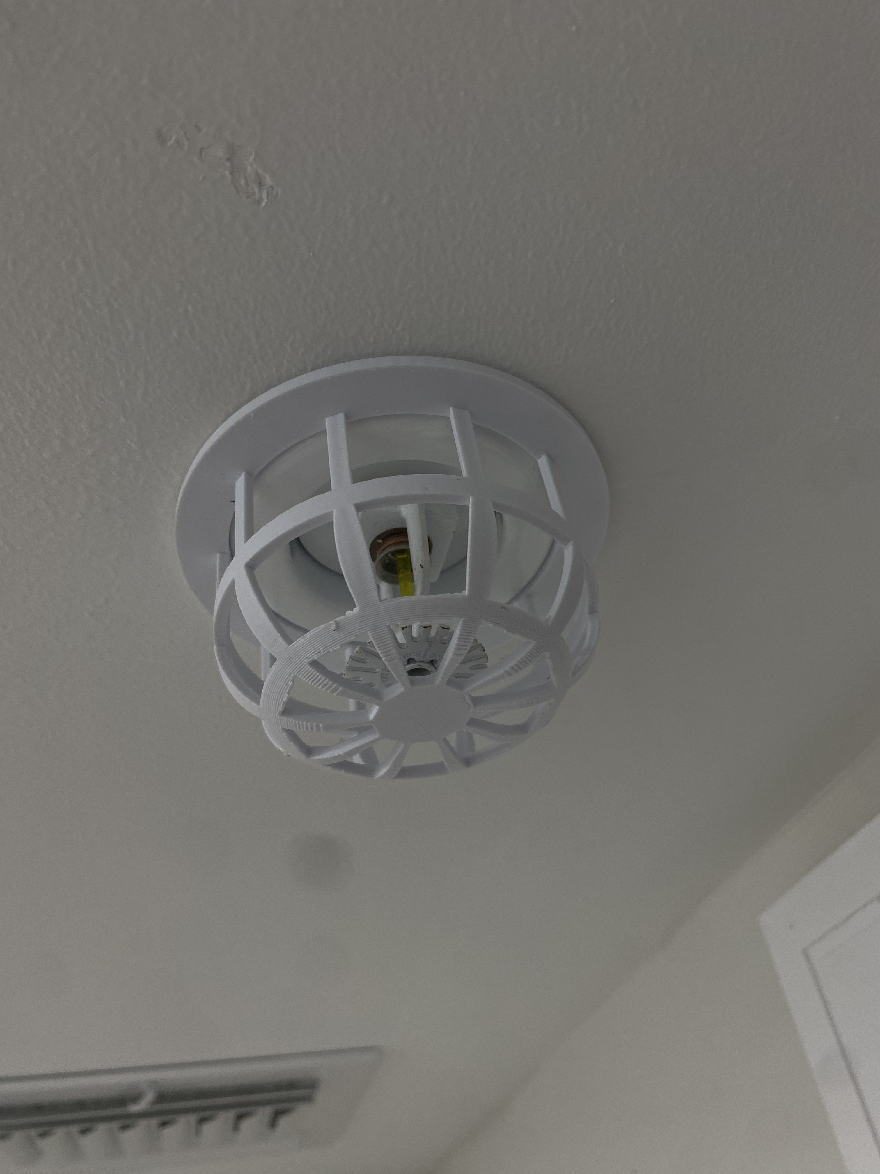 Wall sprinkler cage cover installed